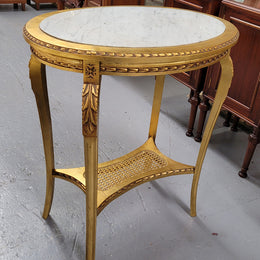 Impressive French oval Louis XVI style gilt and white marble topped two tier lamp/side table. It has been sourced from France and is in good original detailed condition.