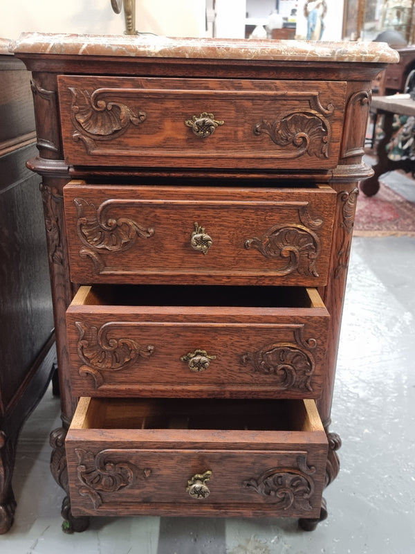 A pair of hard to find French Oak Louis XV style four drawer marble topped bedsides with attractive carvings. They are in good original detailed condition and have been sourced from France.