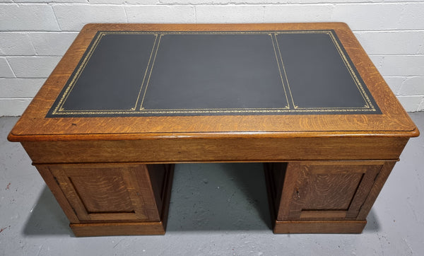 Amazing American Oak full partners leather top desk. Plenty of storage space with nine drawers on one side and two cupboards of the oppsite side. It is in good restored condition and has a new leather and gold tooled inset top.