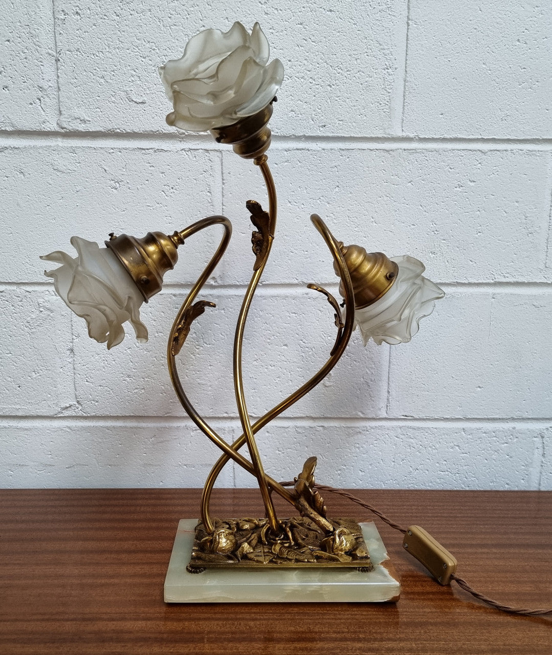Art Deco alabaster and gilt brass table lamp with three branches and glass tulip shades. In good original detailed working condition.