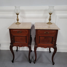Pair of French Antiloopque Louis XV style Walnut and marble top bedsides. They have lovely carvings along with a drawer and cupboard space. They are in good original detailed condition and have been sourced from France