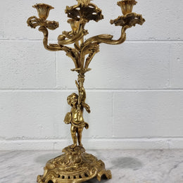 A pretty 19th Century French gilt bronze candelabra featuring a cherub. In good condition. Circa 1880.