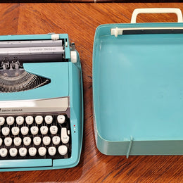 1960's Smith Corona Corsair deluxe portable typewriter. It is in working condition with a used ribbon, and comes with everything pictured. It has been sourced locally.