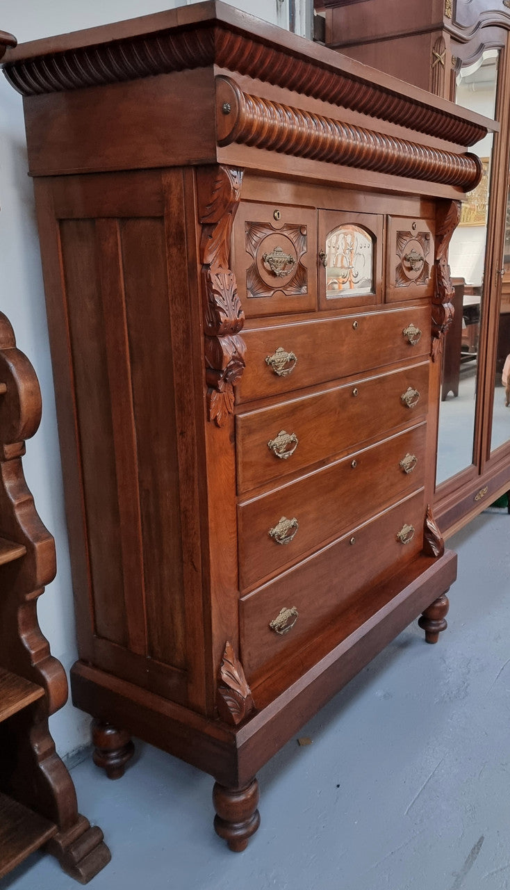 A 19th Century Scottish Mahogany tall boy/ chest of six drawers with small cabinet section at the top. Beautiful carvings and easily comes apart into three sections making transport for moving into place easy. In good original detailed condition.