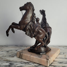 French Art Deco cold painted bronze metal marley horses style statue on a marble base. It is in good condition.