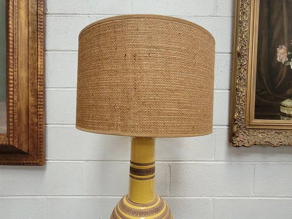A large and impressive Vintage Mid-Century Bitossi Italian terra cotta lamp base and shade. Incised repeating geometric terra cotta pattern creates a tactile element which is incorporated with stunning shining thick yellow glaze to create the sculptural form of the base.