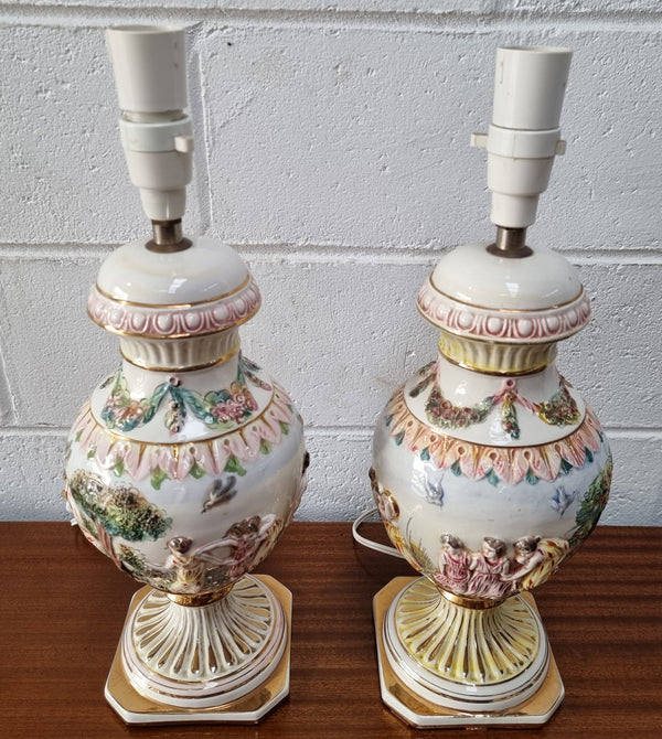 Pair of hand painted capodimonte vintage table lamps. In good original detailed working condition.