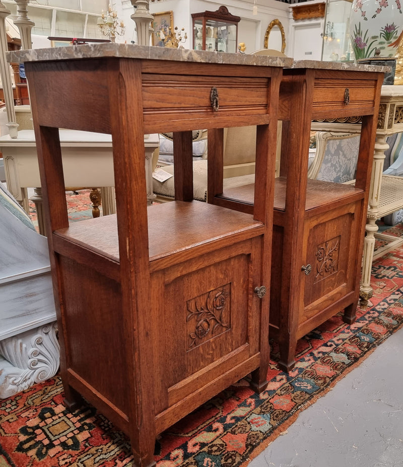 Charming pair of French Oak Arts and Crafts bedsides with shelf, cupboard with carving and marble top.  They have been sourced from France and are in good original detailed condition.