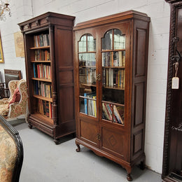 Beautiful four door Walnut bookcase with glass doors. The top section has two fully adjustable shelves and it is of pleasing narrow proportions. It is in good original detailed condition.