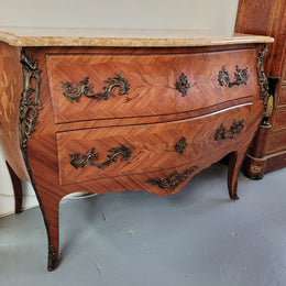 French Louis XV style marquetry inlaid two drawer marble top commode with deorative ormolu trim. In good original detailed condition with working double lock and key.