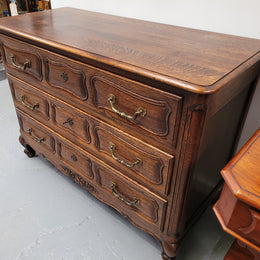 French Provincial Oak three drawer wooden top commode. It has elegant carvings and handles. It has been sourced from France and is in good original detailed condition.