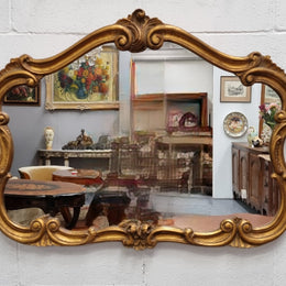 French Louis XV style wood carved and gilded mirror. Mirror is original and showing signs of age. It has been sourced from France and  in good original condition.