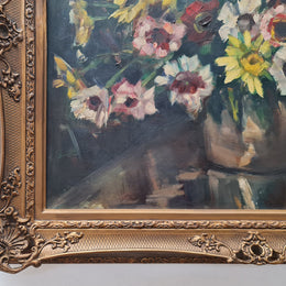 Sourced in France is this beautiful floral oil painting on canvas and framed in a lovely decorative frame. It is in good original condition.