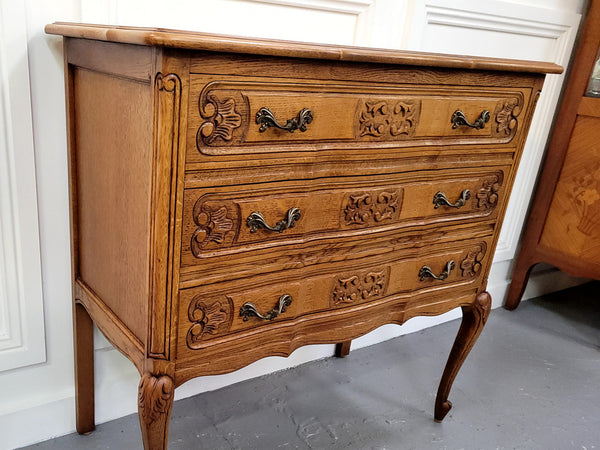 French Oak Louis 15th style nicely carved three drawer wooden top commode. It has been sourced from France and is in good original detailed condition.