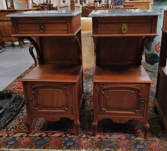 Pair of unusual transitional fruit wood marble top bedside cabinets. They have been sourced from France and are in good original detailed condition.