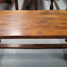 Rustic French Oak stretcher based farmhouse dining table that comfortably seats 6-8 people. It has been sourced from France and is in good original condition.