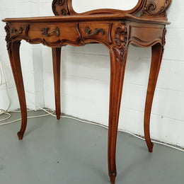 French walnut Antique Louis XV style dressing table of petite size, retaining it's original bevelled edge tilt mirror. In good original condition with three small drawers. Circa 1900.