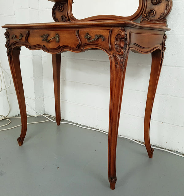 French walnut Antique Louis XV style dressing table of petite size, retaining it's original bevelled edge tilt mirror. In good original condition with three small drawers. Circa 1900.