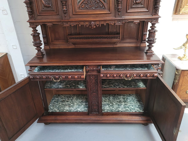 Spectacular French Walnut Renaissance Style buffet with amazing detailed carvings. Plenty of storage space with five cupboards and two large drawers. The three top cupboards open up to two adjustable shelves in each section and the two bottom drawers open up to one large fully adjustable shelve. In good original detailed condition.
