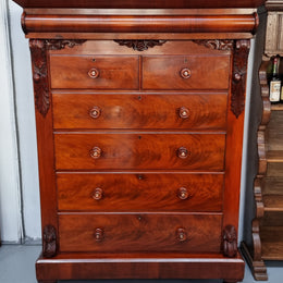 A 19th Century Scottish Flame Mahogany tall boy/ Chest of six drawers. Beautiful carvings and easily comes apart into three sections making transport o0r moving into place easy. In good original detailed condition.