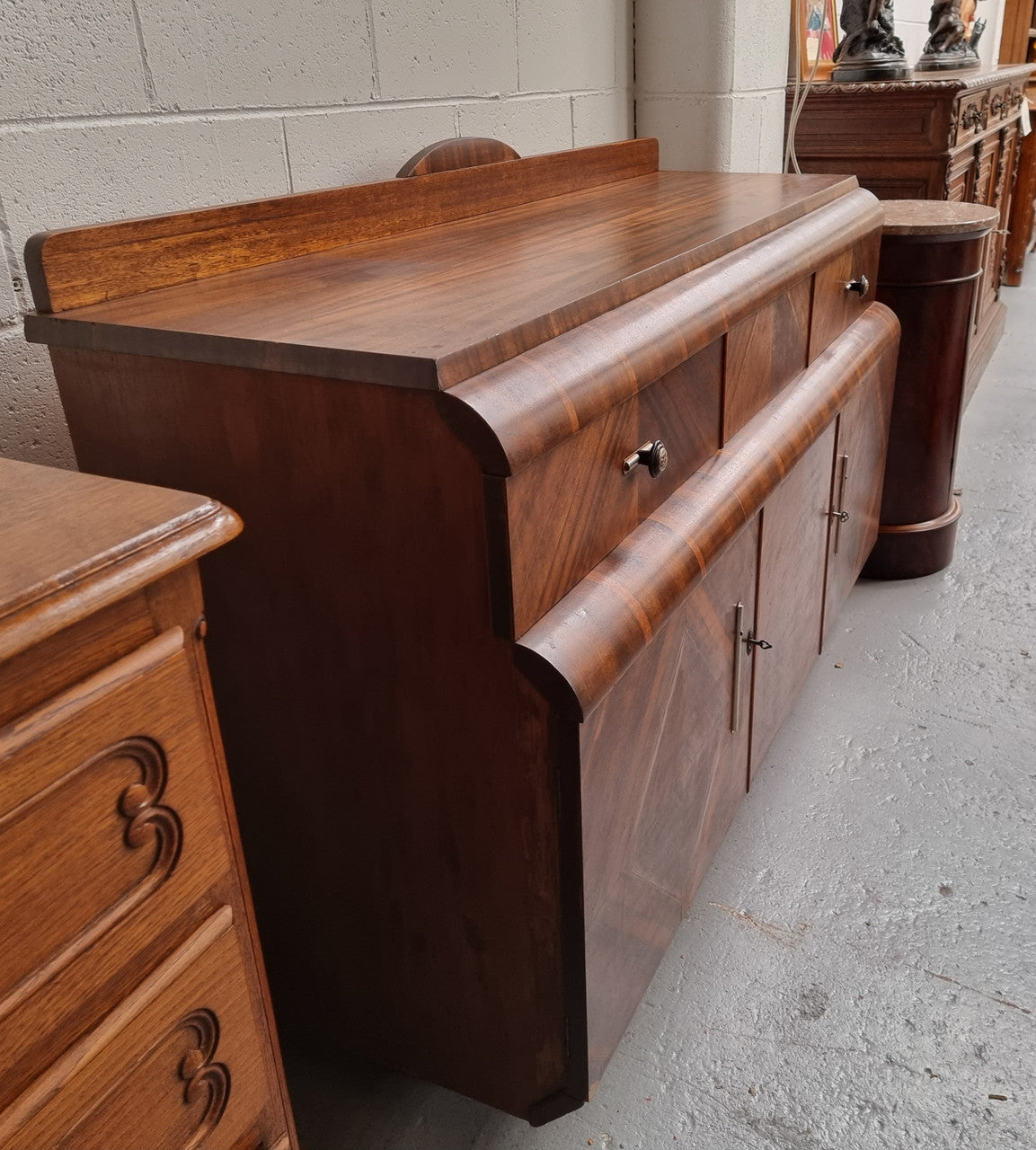 Vintage Walnut Art Deco “Waterfall” sideboard buffet with two drawers and two doors. It is in good original condition and has been sourced locally.