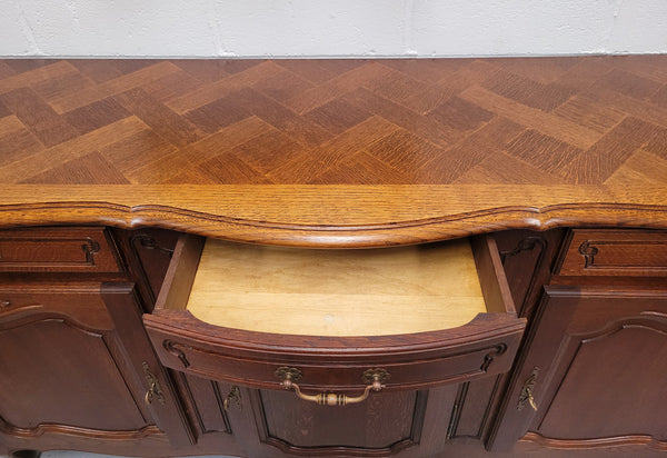 French Oak Louis XV style three drawer three door parquetry top sideboard. It has been sourced from France and is in good original detailed condition.