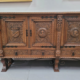 Large French Oak Renaissance style four door sideboard/buffet. Great decorative item with amazing carvings and stunning iron work on base. It is in good original detailed condition. Can pull apart completely making it easier to move.