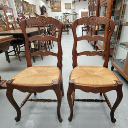 Set of six Louis XV style French Oak rush seat dining chairs. These chairs are very sturdy and have been professionally re-glued to ensure long lasting strength and sturdiness. They are in very good original detailed condition.