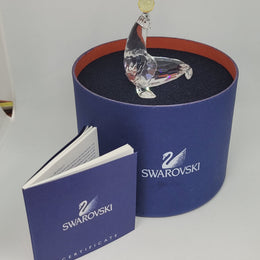 Swarovski crystal juggling seal. Jet eyes and balancing pink & yellow balls. Introduced 2003 and retired 2007.  Comes with original box.