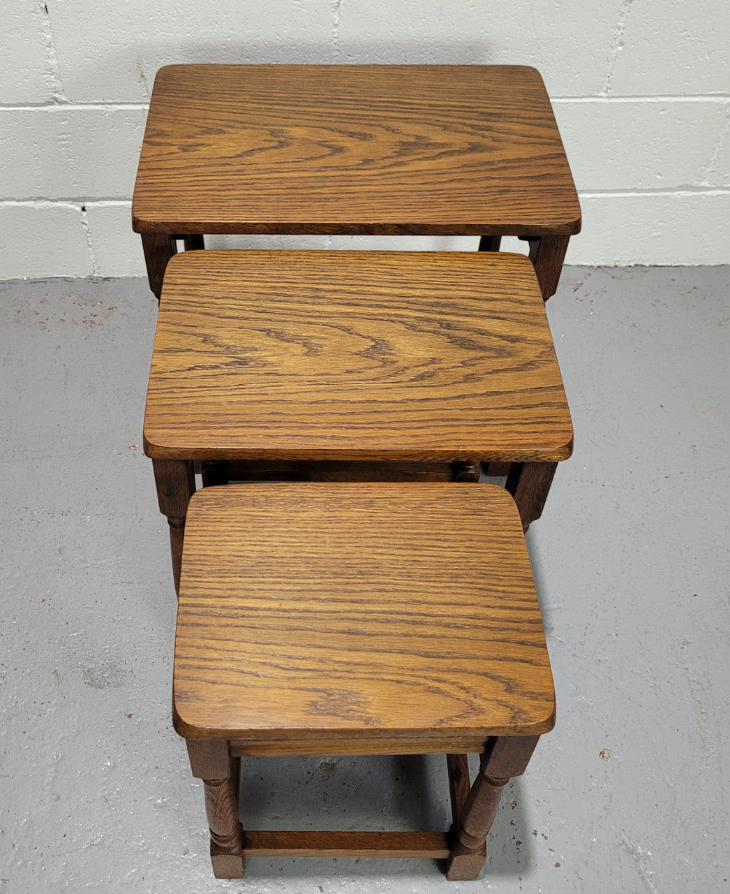 Lovely tudor oak style three nest tables. Circa 1950, In good original detailed condition.