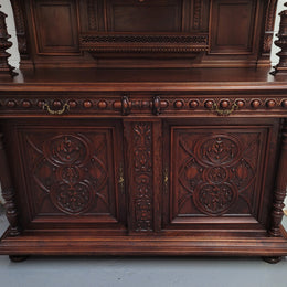 Spectacular French Walnut Renaissance Style buffet with amazing detailed carvings. Plenty of storage space with five cupboards and two large drawers. The three top cupboards open up to two adjustable shelves in each section and the two bottom drawers open up to one large fully adjustable shelve. In good original detailed condition.