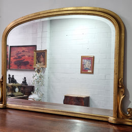 Antique arched over mantel gilt mirror. It has been sourced from France and is in good original detailed condition.