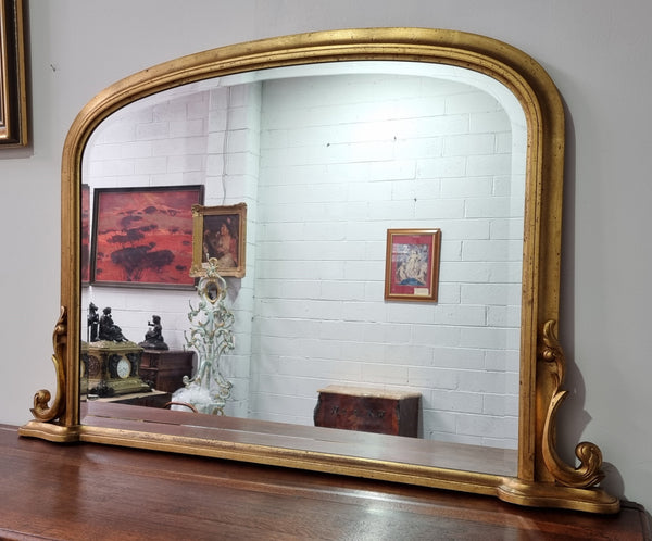 Antique arched over mantel gilt mirror. It has been sourced from France and is in good original detailed condition.