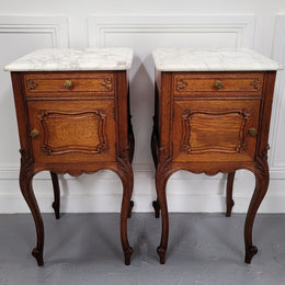 Pair of French Antique Louis XV style Oak marble top night stands. They have beautiful carved cabriole legs and beautiful white marble along with a drawer and cupboard for storage space. They have been sourced from France and are in good original detailed condition.