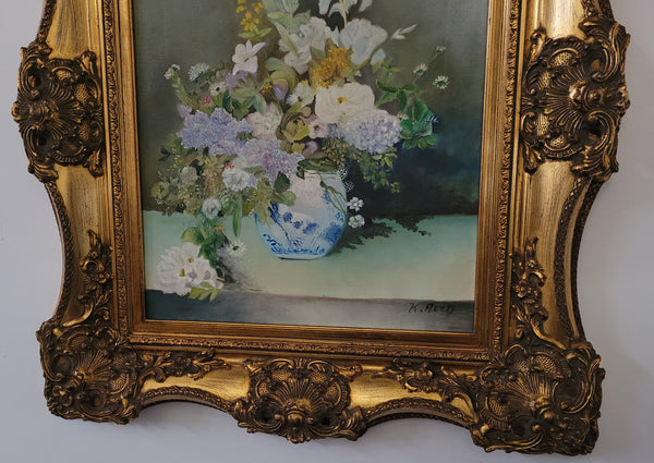 Stunning gilt frame with signed oil on canvas depicting floral arrangement in vase. In good original detailed condition.