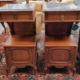 Pair of unusual transitional fruit wood marble top bedside cabinets. They have been sourced from France and are in good original detailed condition.
