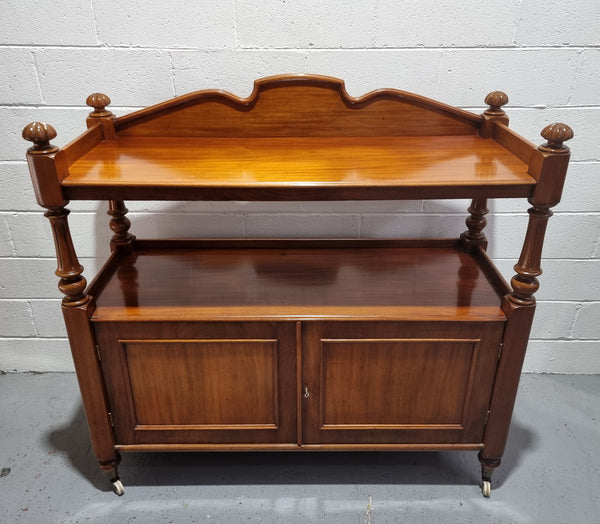 Victorian Mahogany Dumb Waiter with two cupboards, original casters in good detailed condition.