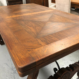French Oak Renaissance style extension table with a lovely parquetry top and decorative carved and iron base in good original detailed condition.