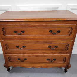French Louis 15th style Oak three drawer chest of drawers with wooden top. It has been sourced from France and is in good original detailed condition.