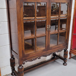 Tudor oak 2 door astral glaze and beveled glass bookcase.  Good original condition. Circa 1930s.