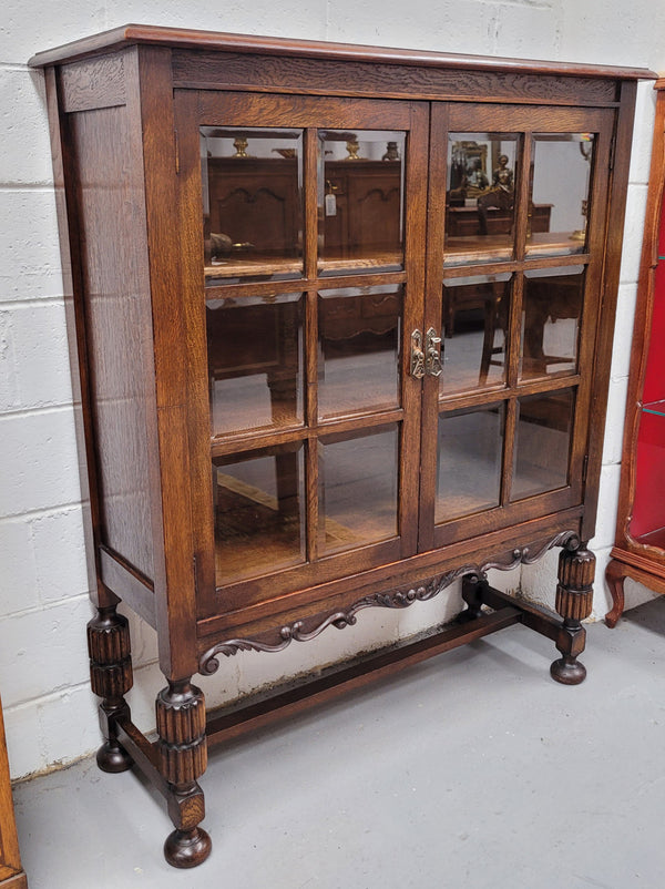 Tudor oak 2 door astral glaze and beveled glass bookcase.  Good original condition. Circa 1930s.