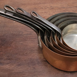 Set of five copper sauce pans with foundry stamp. They have been sourced from France and are in good original detailed condition.