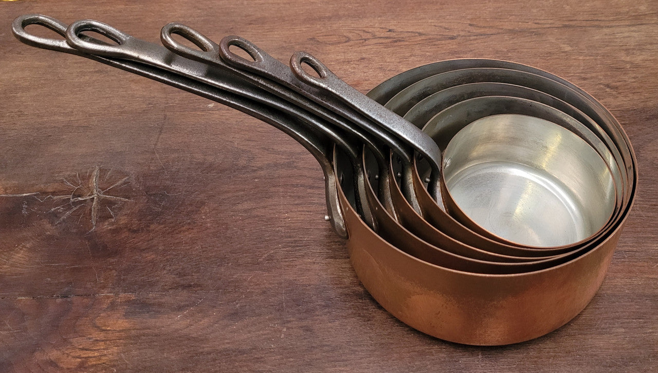 Set of five copper sauce pans with foundry stamp. They have been sourced from France and are in good original detailed condition.