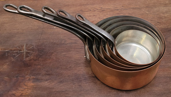 Set of five copper sauce pans with foundry stamp. They have been sourced from France and are in good original detailed condition.