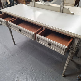 French Louis XVI style painted dresser / console with beveled oval mirror and three drawers. Sourced from France and in good original detailed condition.