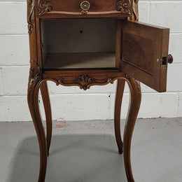 Beautiful French Walnut carved bedside cabinet with a lovely grey coloured inset marble top. The inside of the cupboard is also marble lined and it is in good original detailed condition.