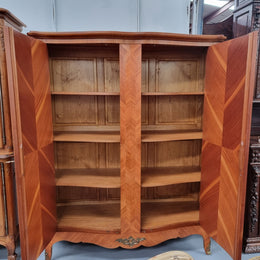 Charming French Louis XV Style Marquetry Inlaid Two Door Armoire. Features three adjustable shelves and ormolu trim. It has been sourced from France and is in good original condition.