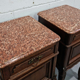 Stunning pair of French dark Oak bedside cabinets with a beautiful coloured marble top. They have one drawer and cupboard. They are in good original detailed condition.