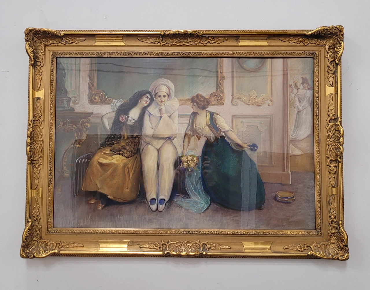 Delightful signed pastel behind glass of Pierrot and young women in an ornate gilt frame. In good original detailed condition.