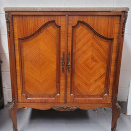 Stunning compact Louis 15th style two door walnut cabinet with ormolu trim and marble top. It is in good original condition.